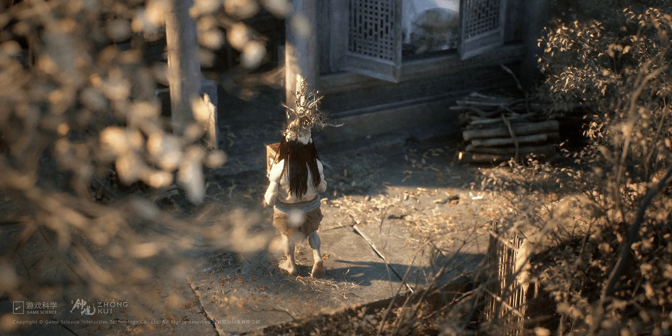 Official Black Myth Zhong Kui still showing a figure on a leaf-covered path before a masonry and timber building